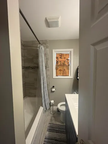 a room with water heater and wooden cabinets