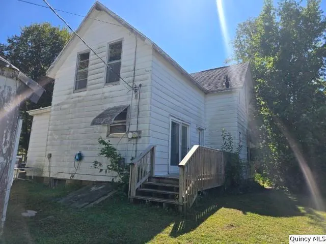 a view of a deck with couches table and chairs with wooden floor and plants