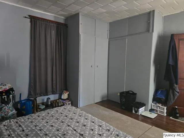 a bedroom with a bed a mirror and a desk