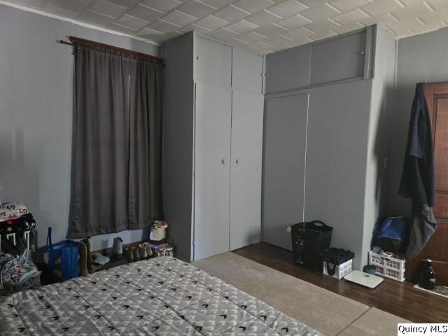 445 Wilcox Street Warsaw, IL 62379 - Photo 6 of 29 a bedroom with a bed a mirror and a desk