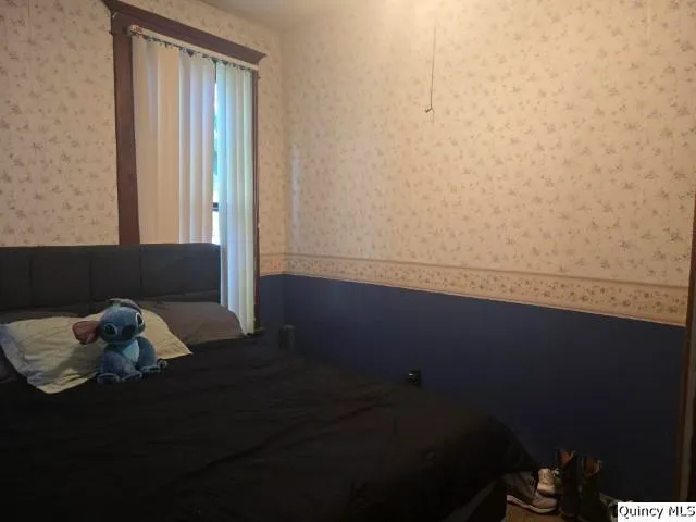 a room with wooden floor and a window