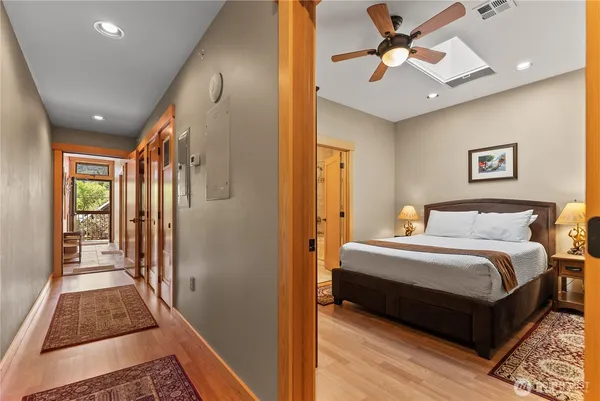 a bed sitting in a bedroom next to a window