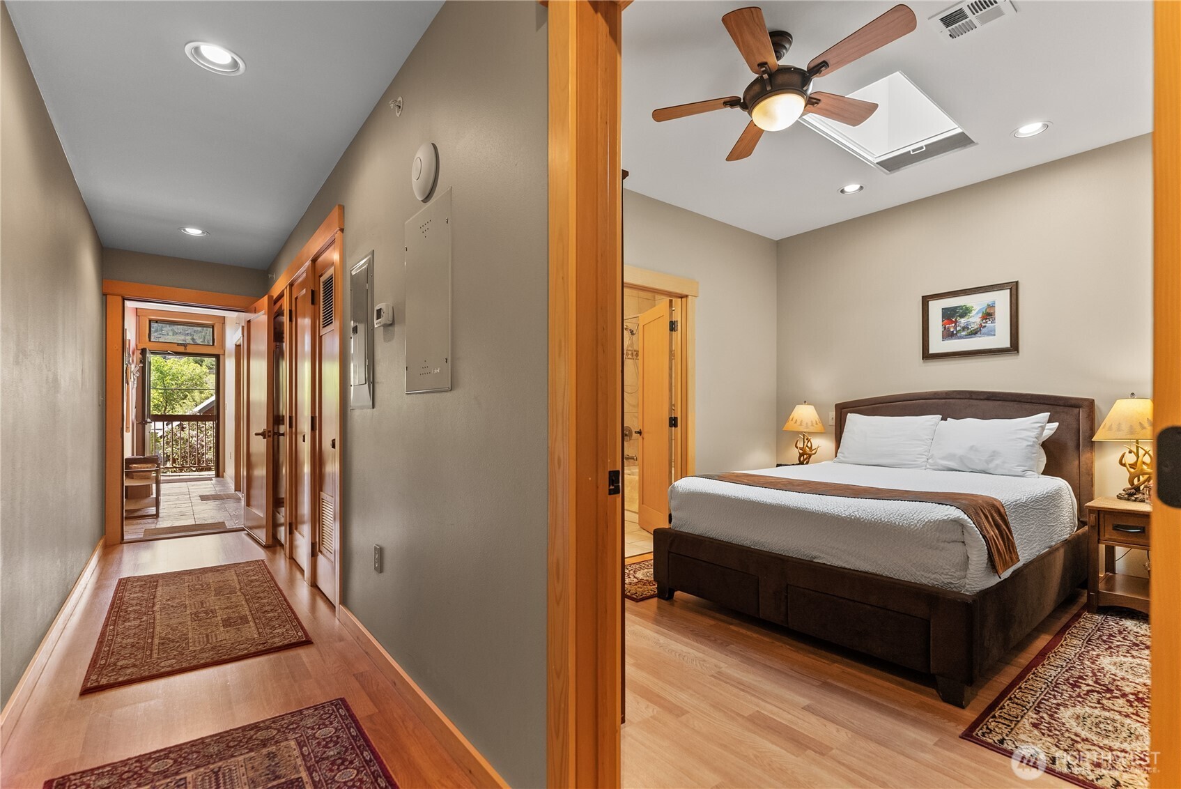 140 Twisp Avenue, Unit 204 Twisp, WA 98856 - Photo 15 of 40 a spacious bedroom with a bed and a chandelier