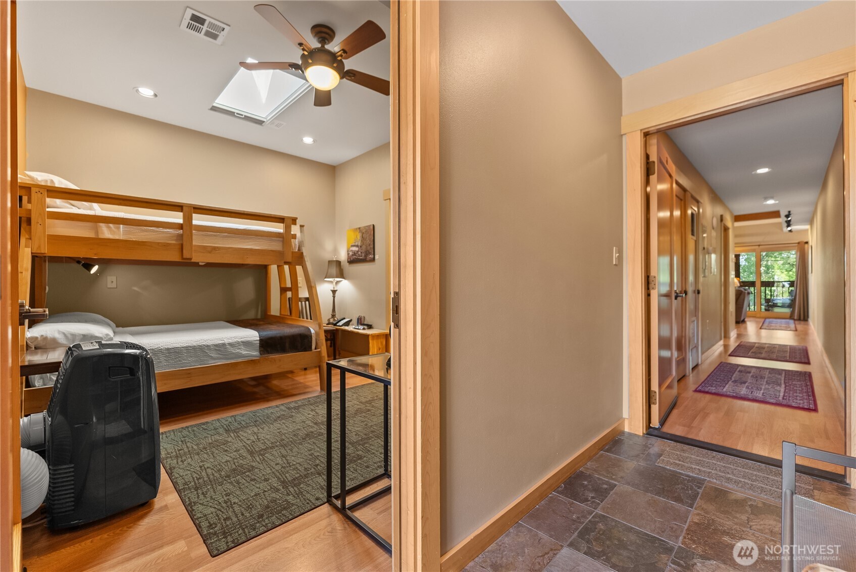 140 Twisp Avenue, Unit 204 Twisp, WA 98856 - Photo 28 of 40 a bedroom with a bed and a chandelier