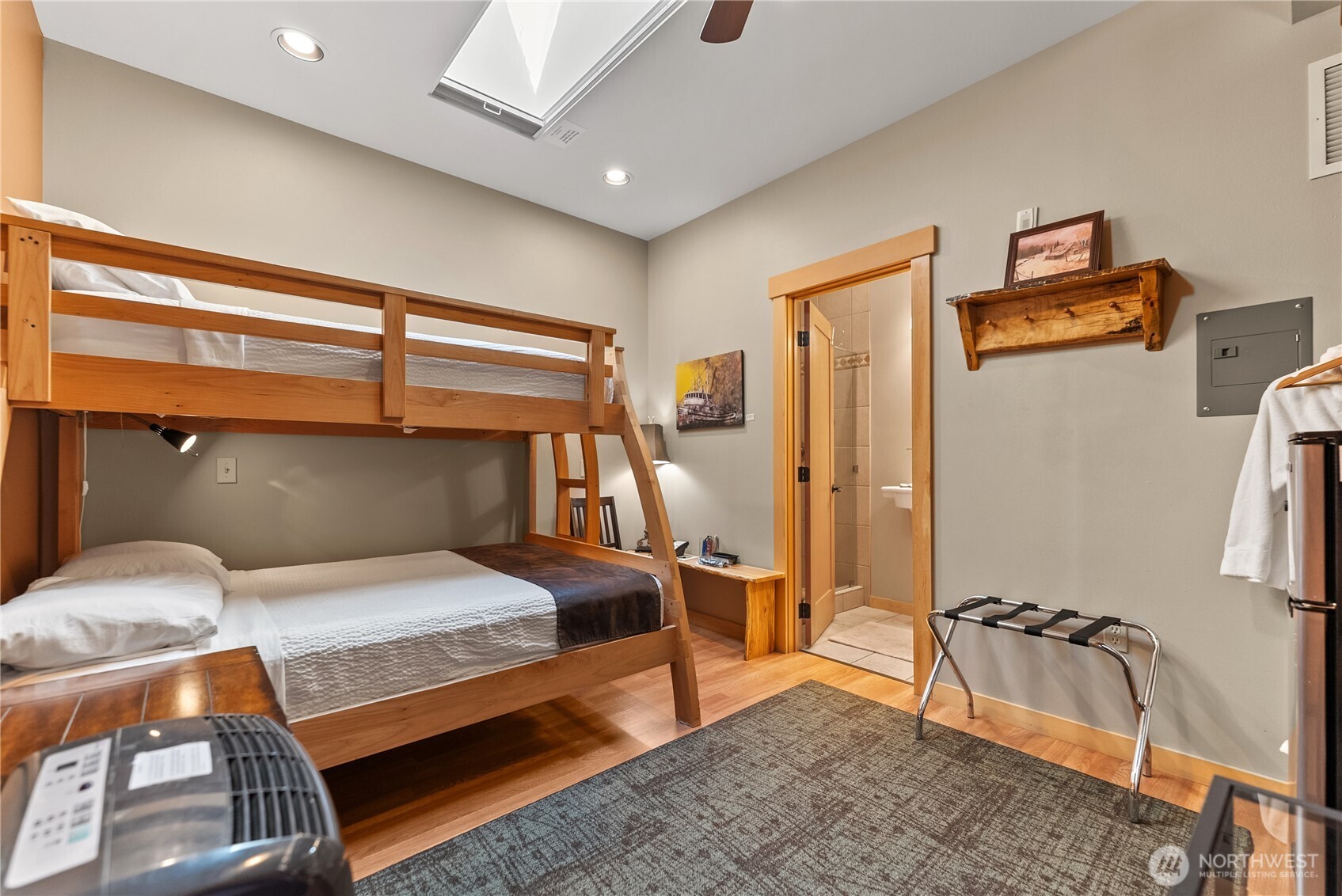 140 Twisp Avenue, Unit 204 Twisp, WA 98856 - Photo 30 of 40 a bedroom with a bed and wooden floor