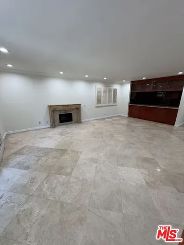 a view of empty room with a fireplace
