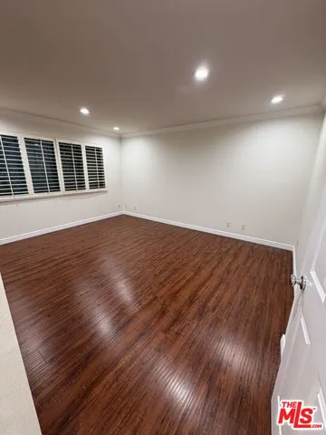 an empty room with wooden floor