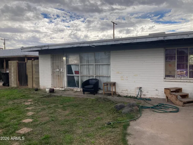 a backyard of a house with barbeque oven and barbeque oven