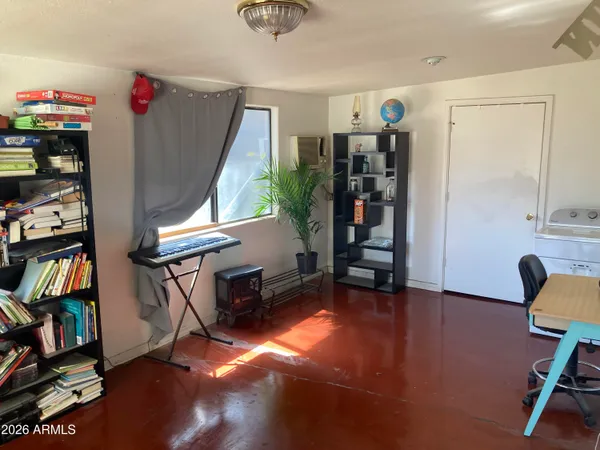 a view of game room with window and wooden floor