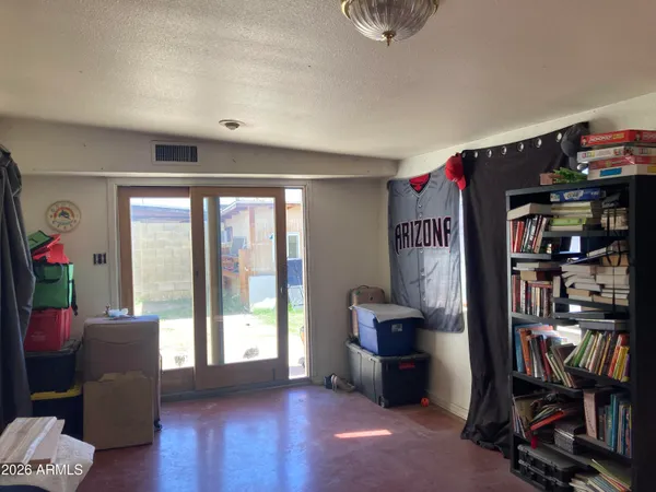 a living room with furniture a bookshelf and a window