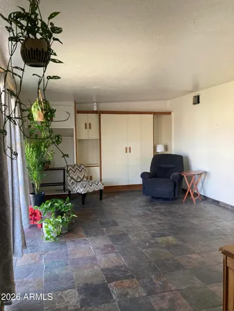 a living room with furniture and flowers