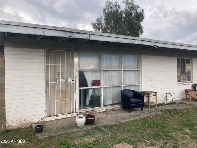 a backyard of a house with barbeque oven