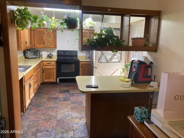 a kitchen with a sink stove and cabinets