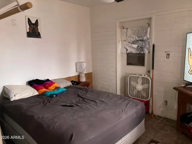 a bedroom with a bed and cabinets