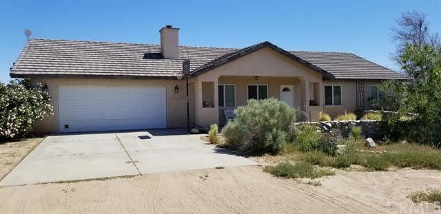 8962 Smoke Tree Road Phelan, CA 92371 - Photo 1 of 1 a front view of house with yard and trees around