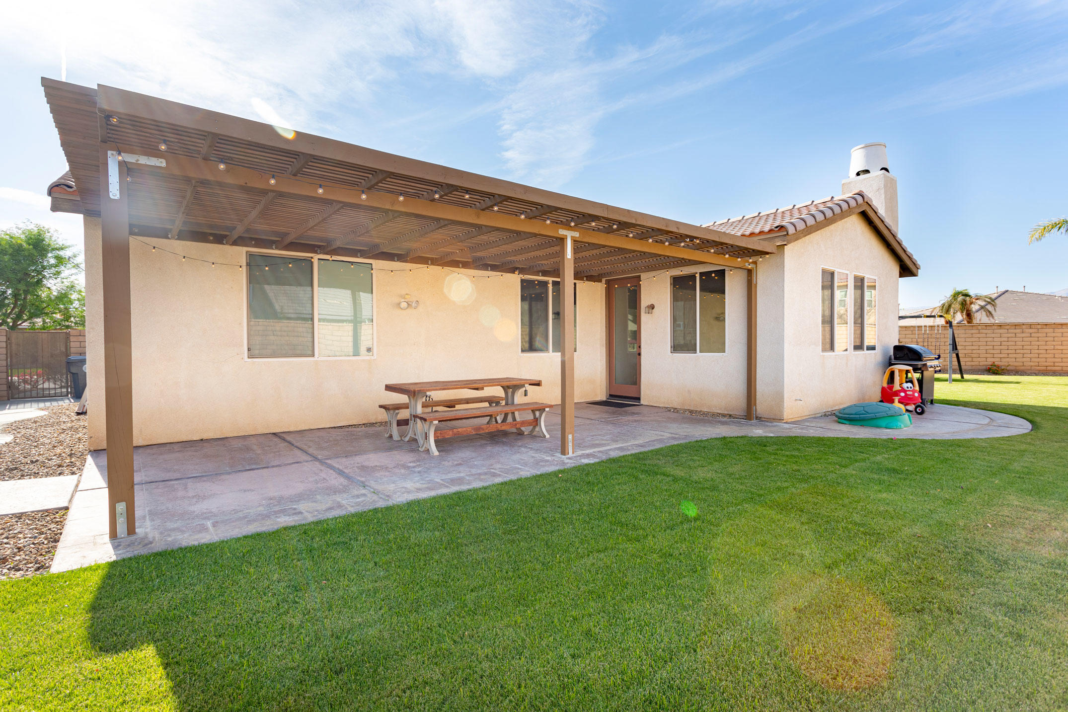 37196 Sandwell Street Indio, CA 92203 - Photo 16 of 34 a backyard of a house with table and chairs