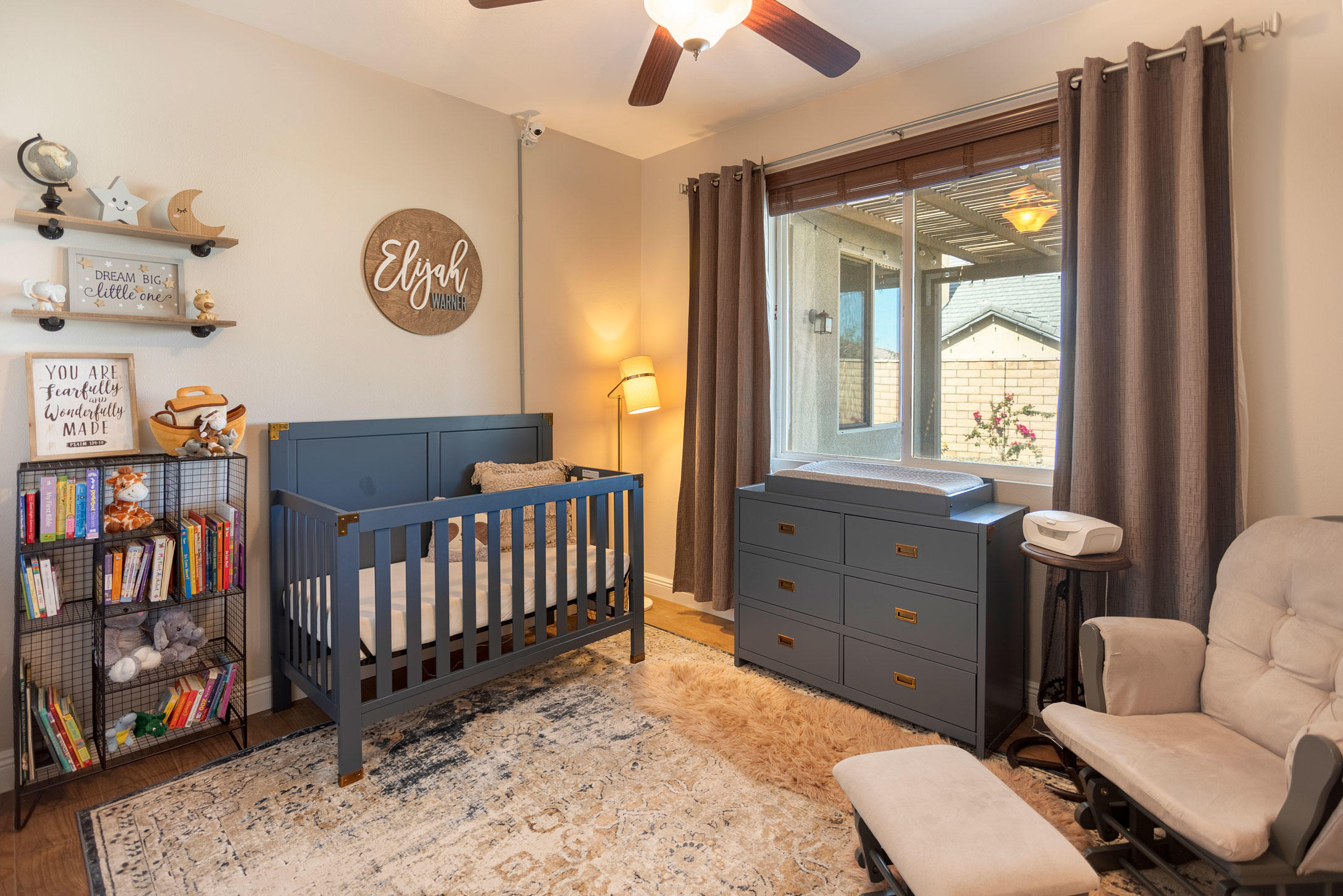 37196 Sandwell Street Indio, CA 92203 - Photo 23 of 34 a living room with furniture a baby crib and a window