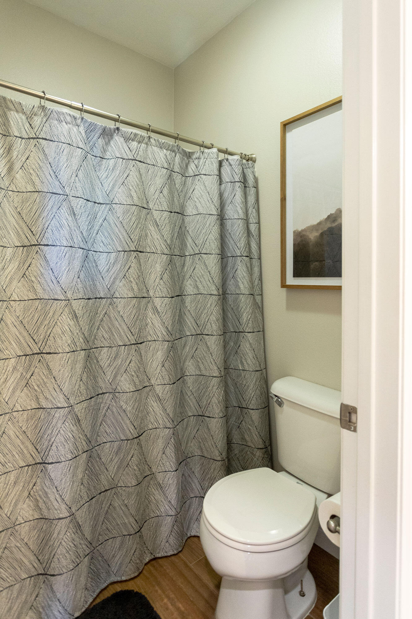 37196 Sandwell Street Indio, CA 92203 - Photo 28 of 34 a white toilet sitting next to a shower curtain
