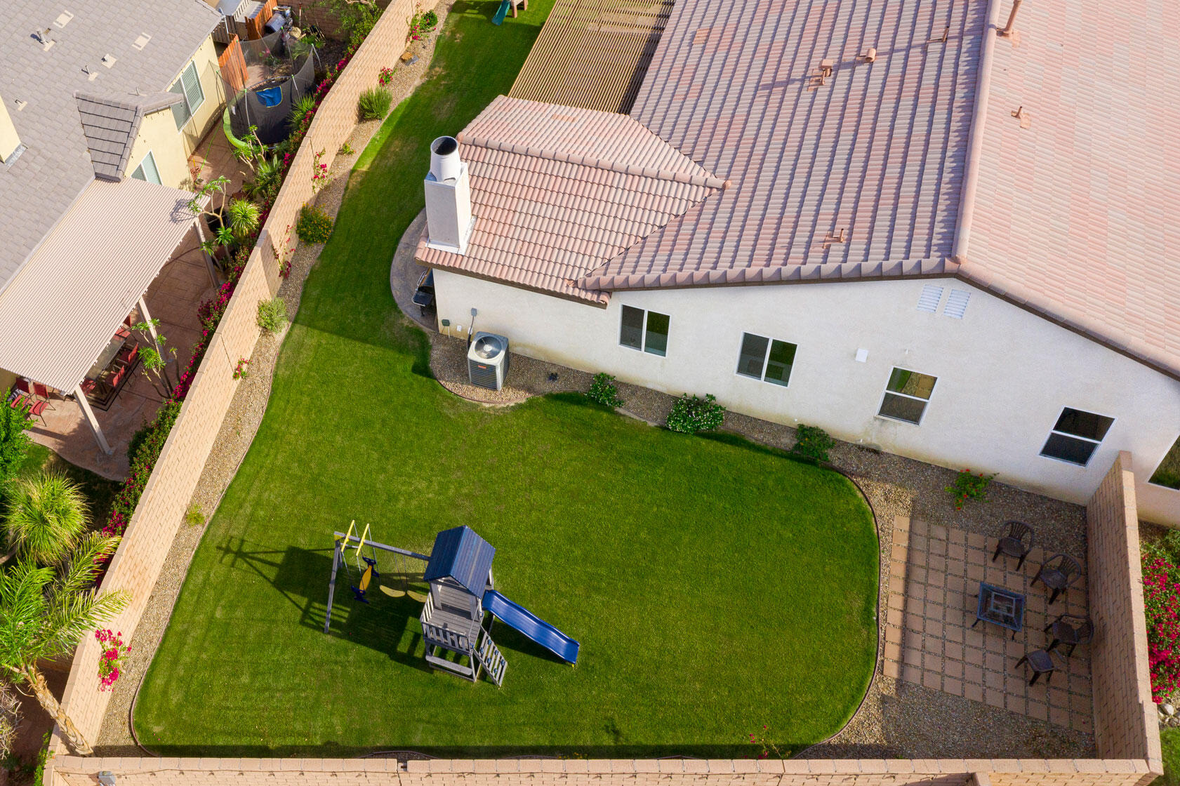 37196 Sandwell Street Indio, CA 92203 - Photo 30 of 34 an aerial view of a house with garden space and sitting area