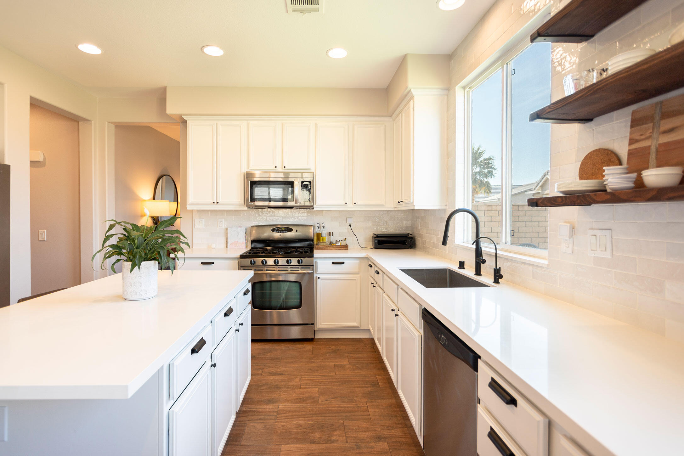 37196 Sandwell Street Indio, CA 92203 - Photo 3 of 34 a kitchen with a sink stove and cabinets