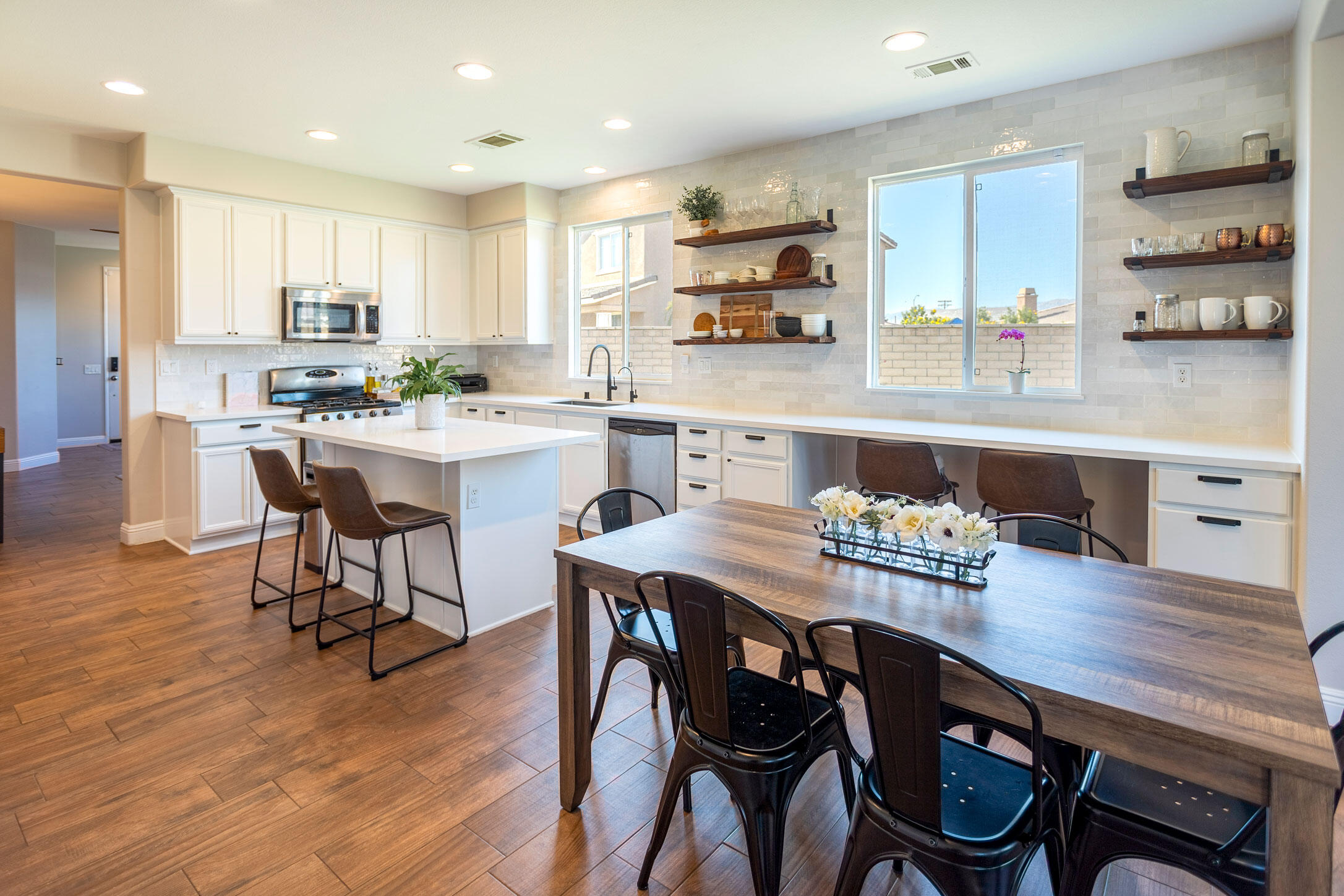 37196 Sandwell Street Indio, CA 92203 - Photo 4 of 34 a kitchen with kitchen island wooden cabinets and dining table