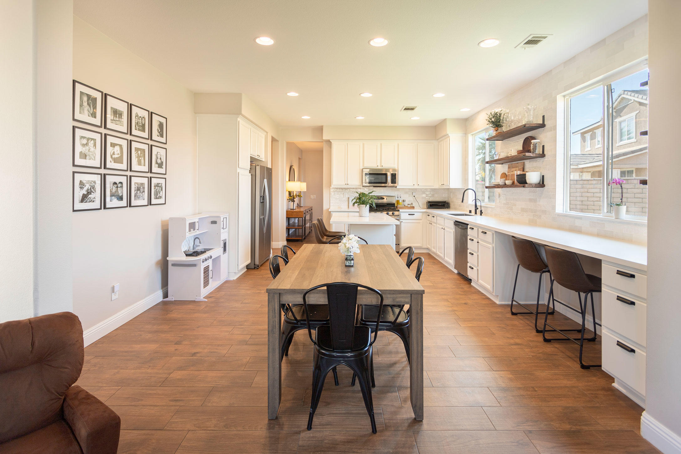 37196 Sandwell Street Indio, CA 92203 - Photo 6 of 34 a large dining hall with stainless steel appliances kitchen island granite countertop a dining table chairs and a refrigerator