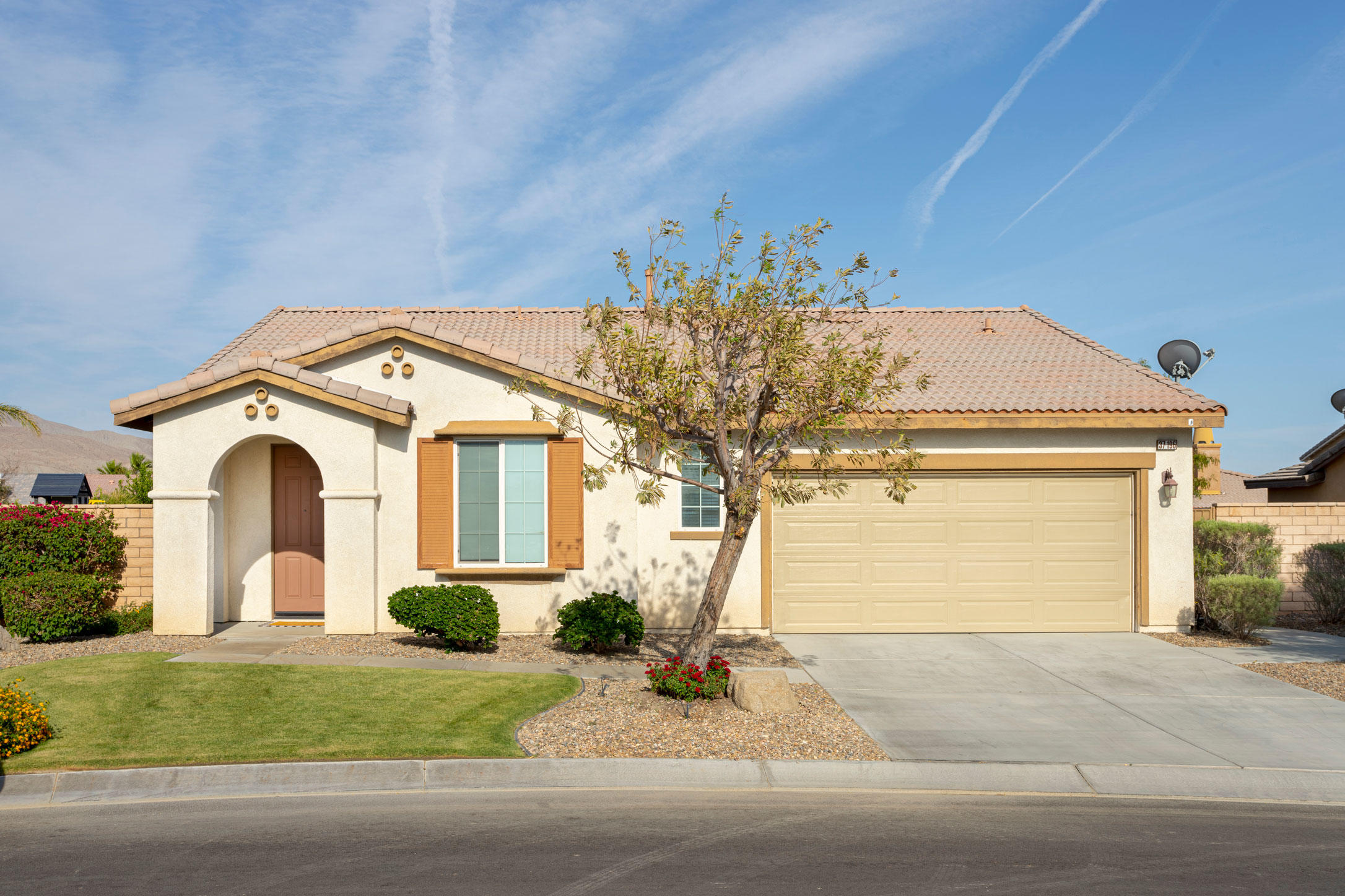 37196 Sandwell Street Indio, CA 92203 - Photo 9 of 34 a front view of a house with garden