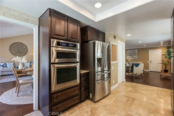 a kitchen with stainless steel appliances granite countertop a sink and a stove