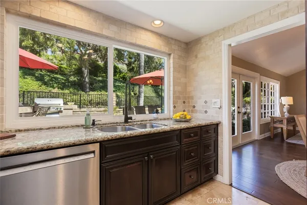 a kitchen with stainless steel appliances granite countertop a refrigerator and a sink
