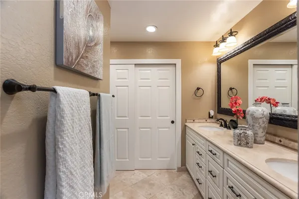 a bathroom with a double vanity sink mirror and toilet