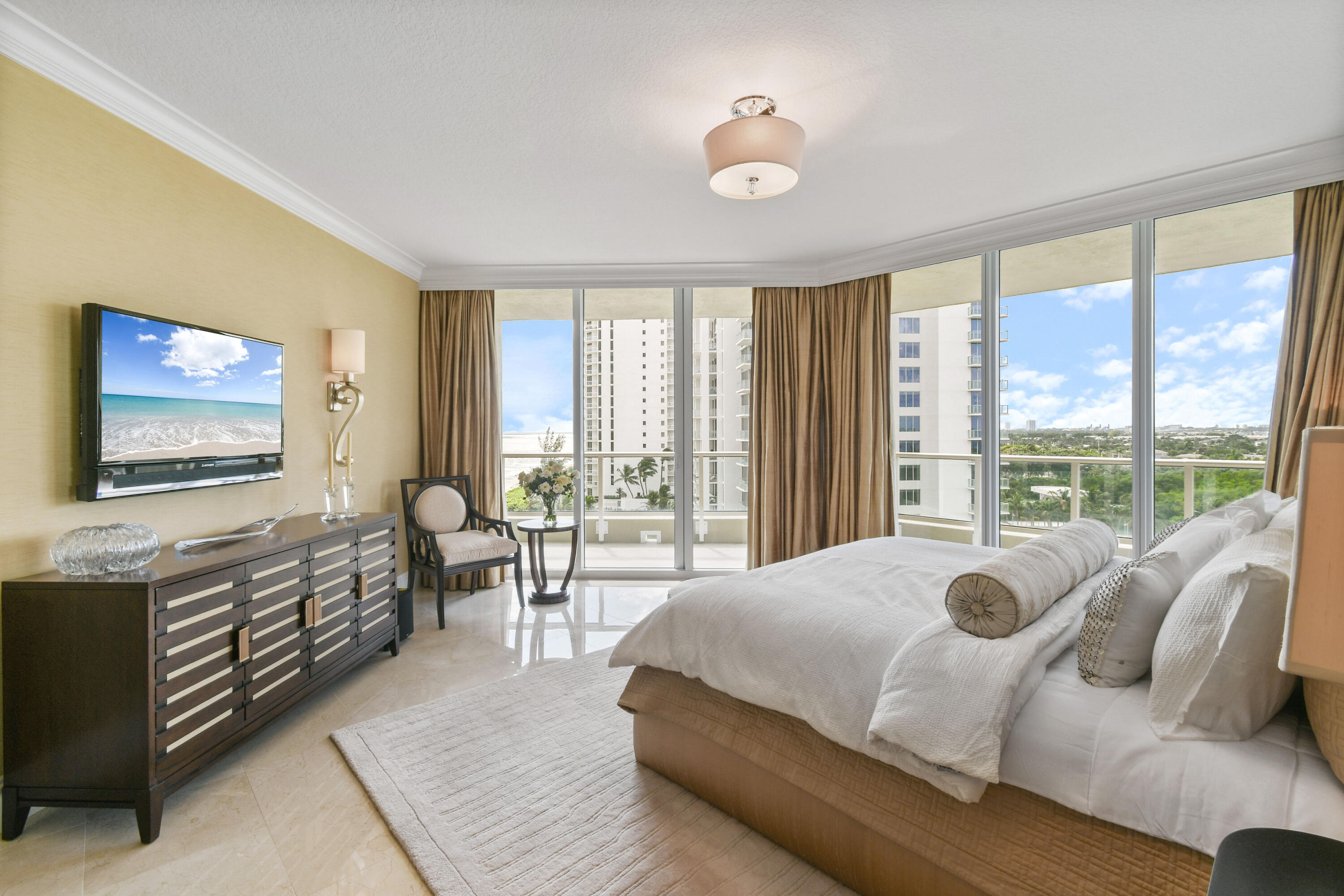 5050 North Ocean Drive, Unit 703 Singer Island, FL 33404 - Photo 11 of 52 a bedroom with a bed and glass windows
