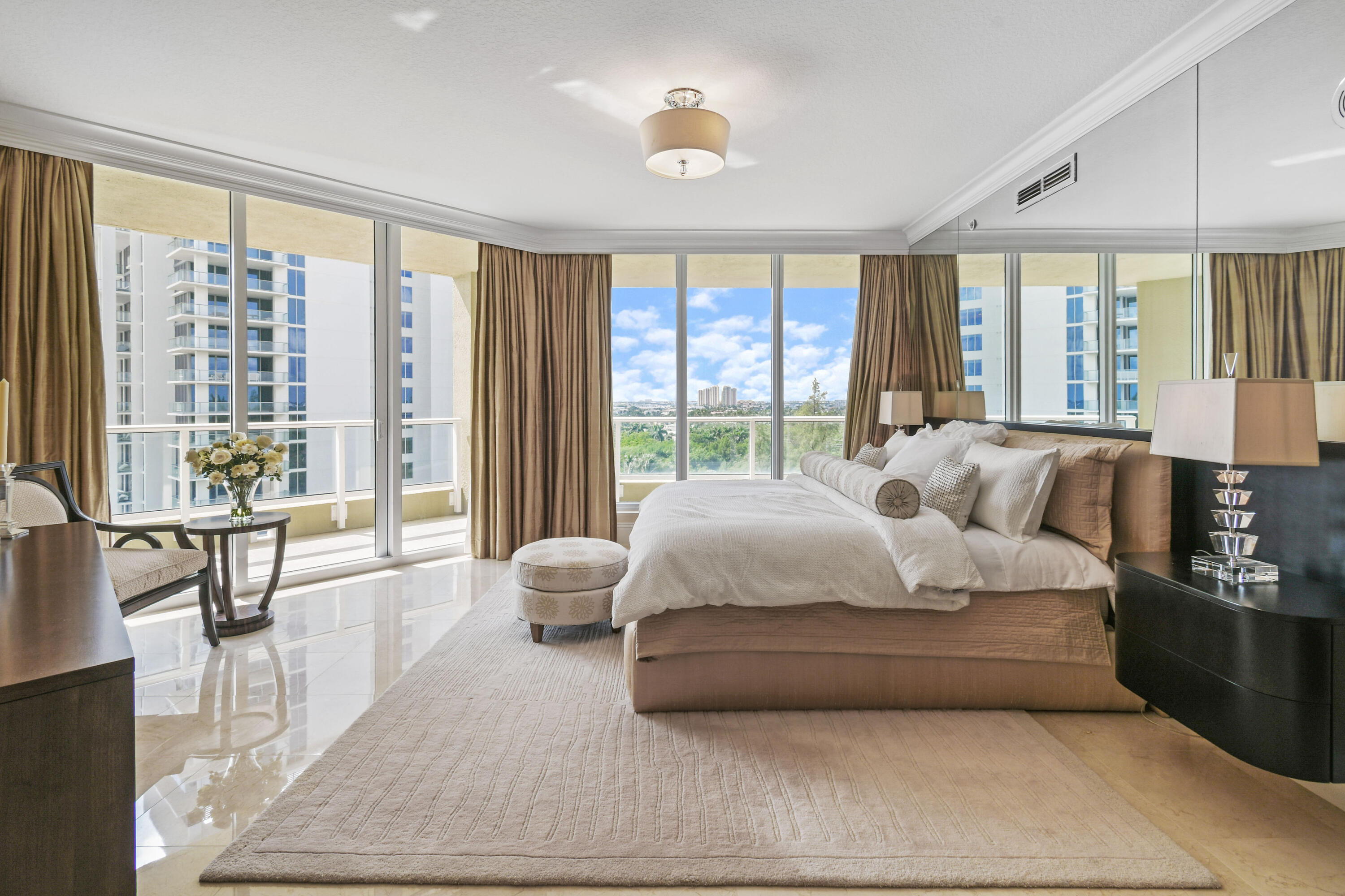 5050 North Ocean Drive, Unit 703 Singer Island, FL 33404 - Photo 12 of 52 a spacious bedroom with a large bed and large windows