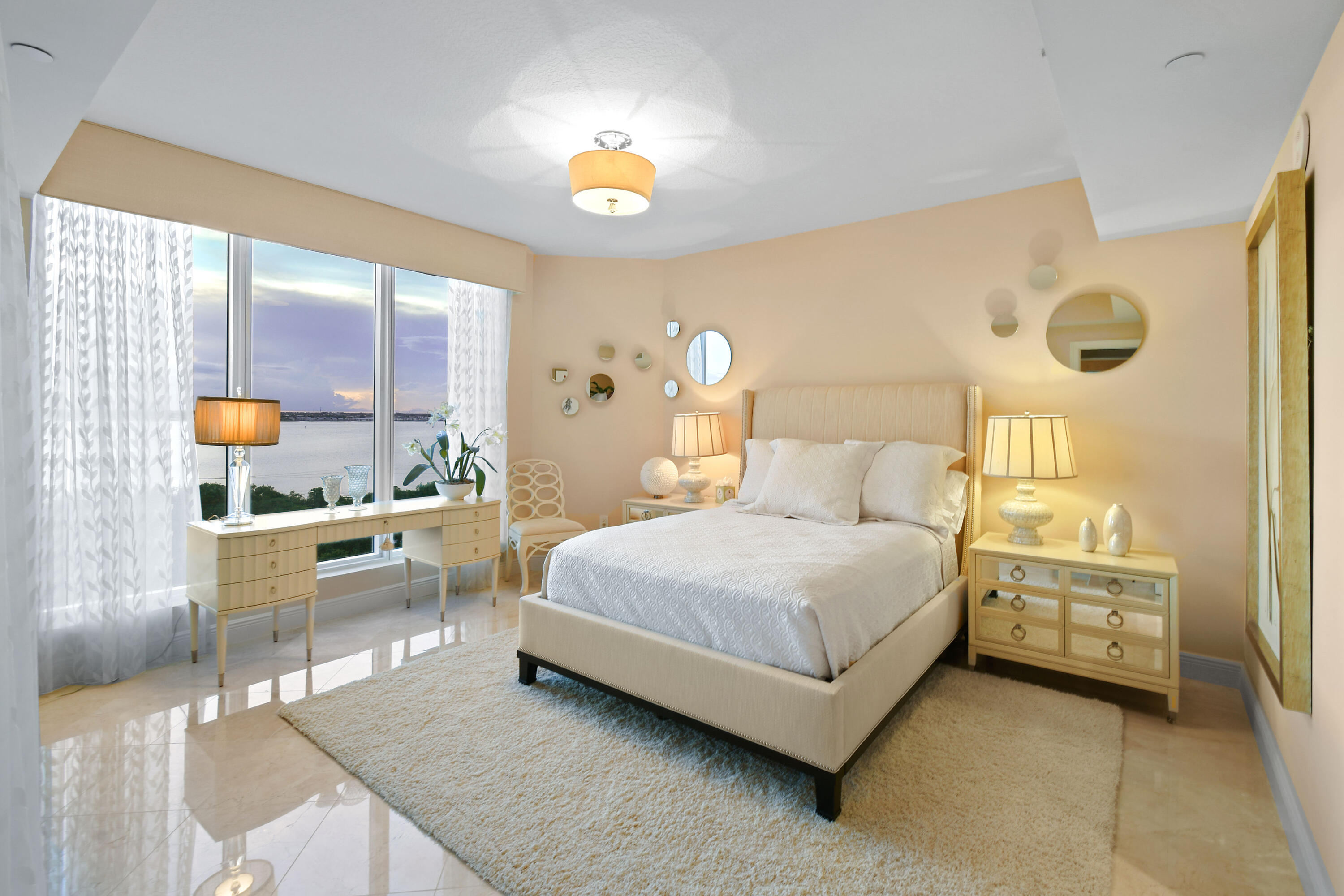 5050 North Ocean Drive, Unit 703 Singer Island, FL 33404 - Photo 16 of 52 a spacious bedroom with a bed and a night stand