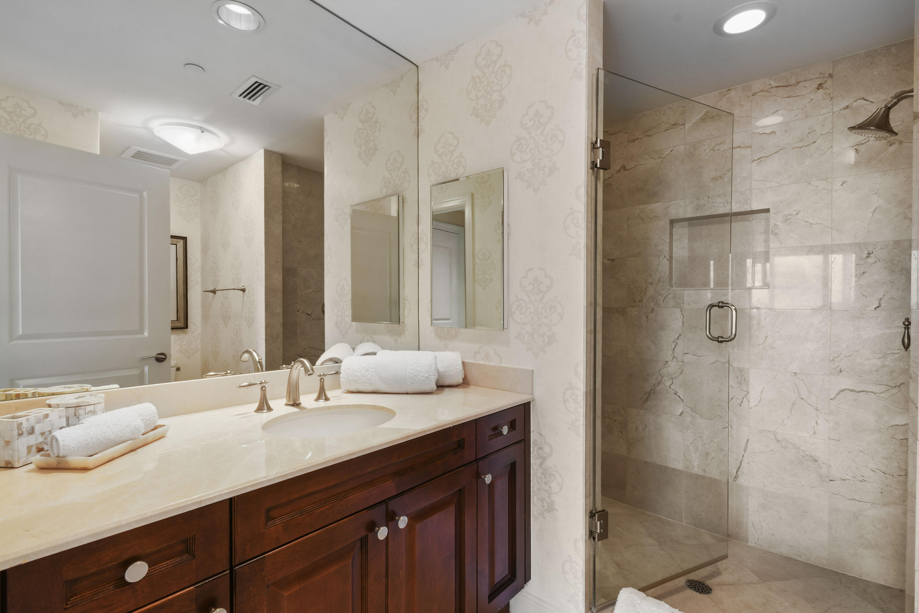 5050 North Ocean Drive, Unit 703 Singer Island, FL 33404 - Photo 17 of 52 a bathroom with a double vanity sink mirror and shower