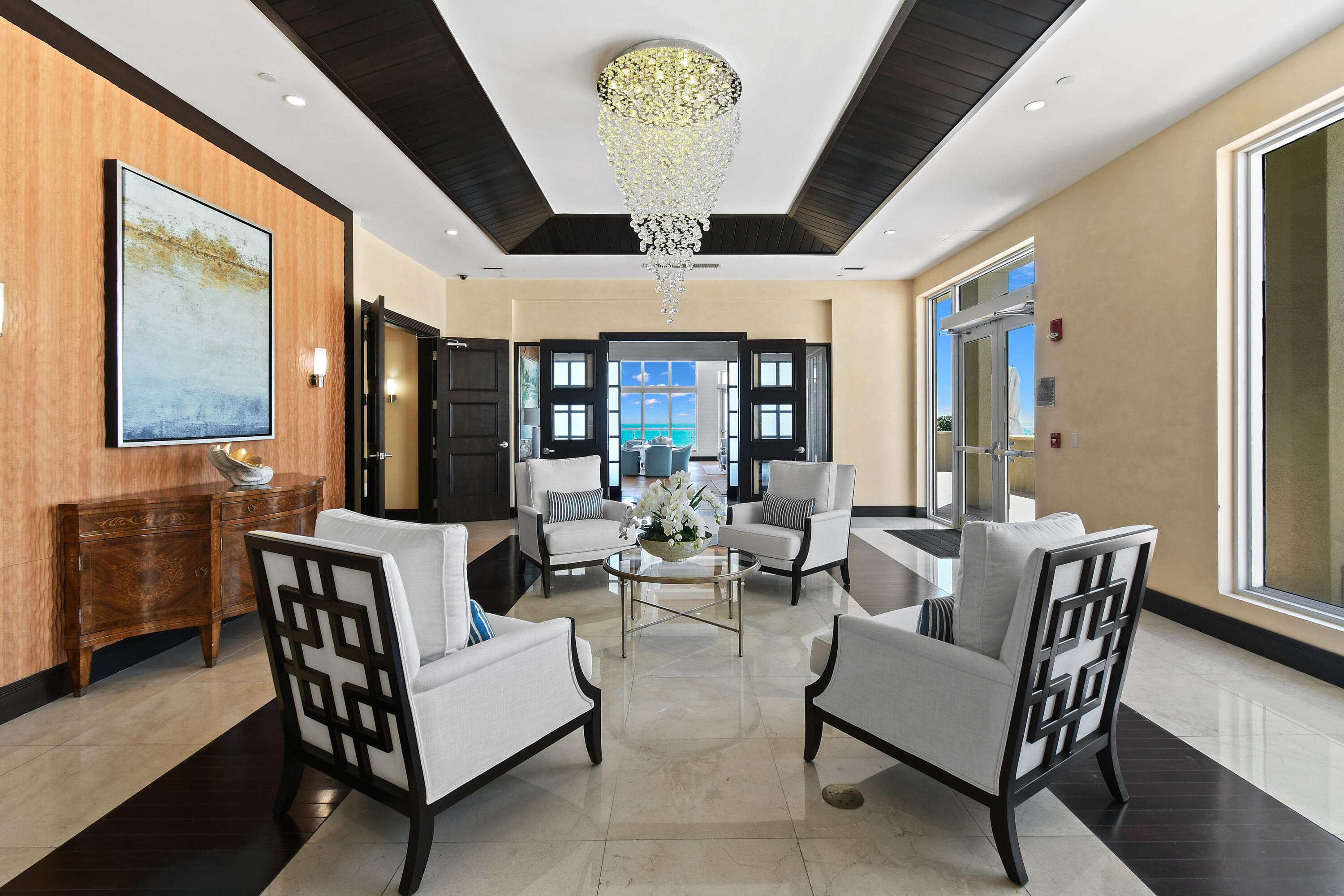 5050 North Ocean Drive, Unit 703 Singer Island, FL 33404 - Photo 44 of 52 a living room with furniture and a chandelier