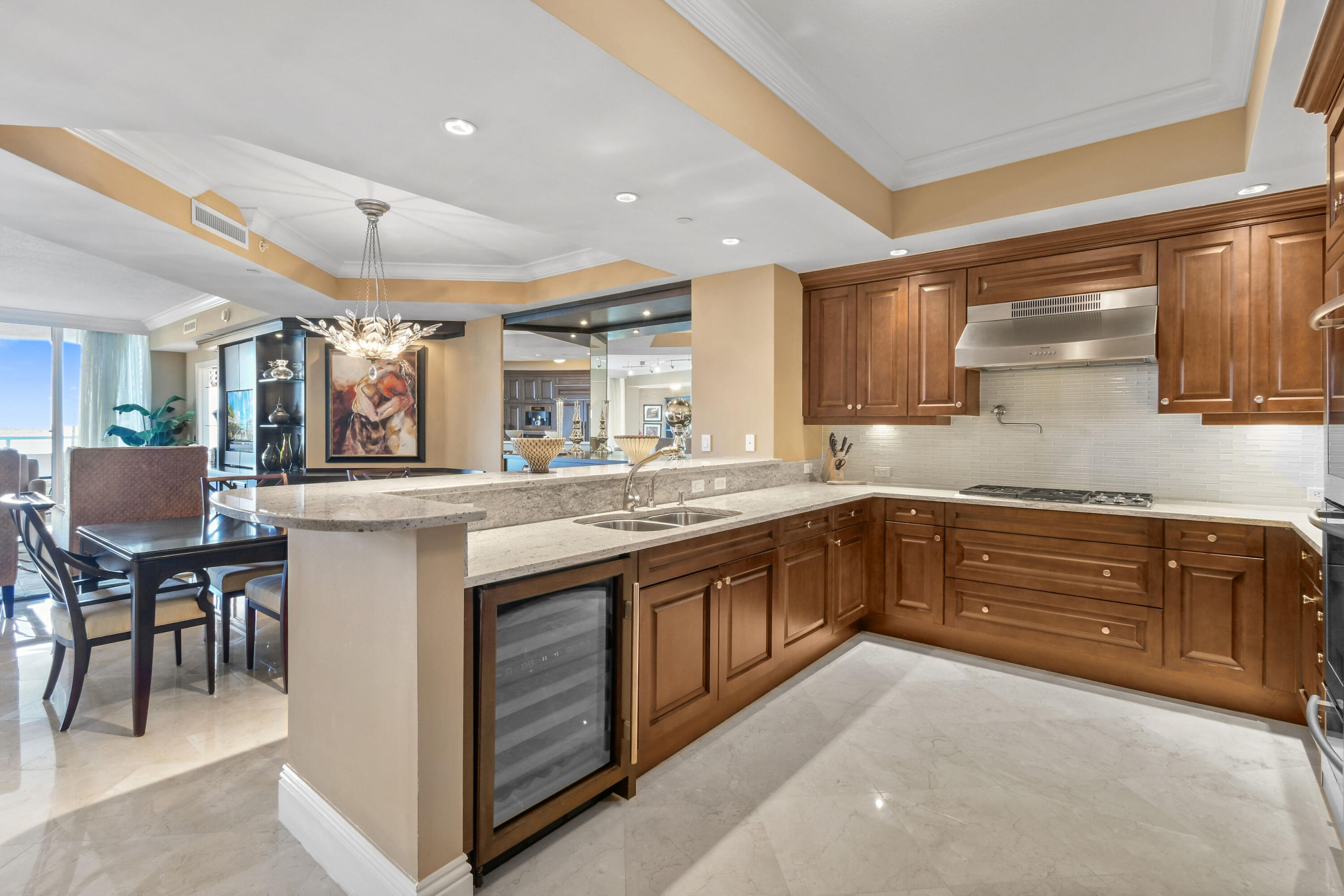 5050 North Ocean Drive, Unit 703 Singer Island, FL 33404 - Photo 9 of 52 a kitchen with stainless steel appliances granite countertop a sink and cabinets