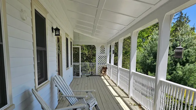 a view of deck with furniture and garden