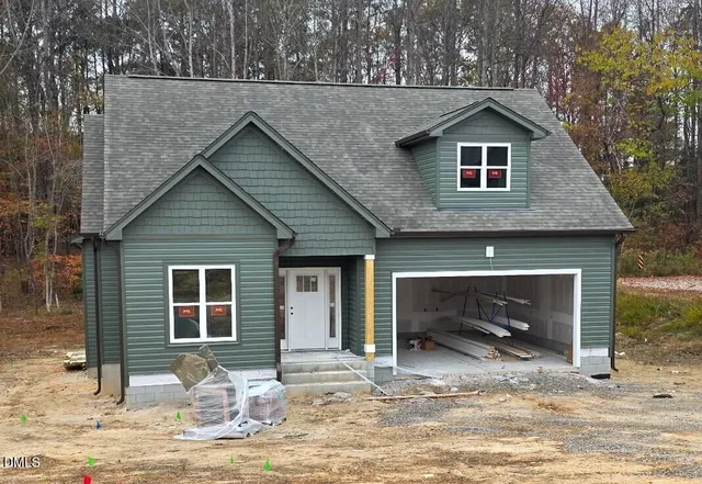 a front view of a house with a yard outdoor seating and barbeque oven