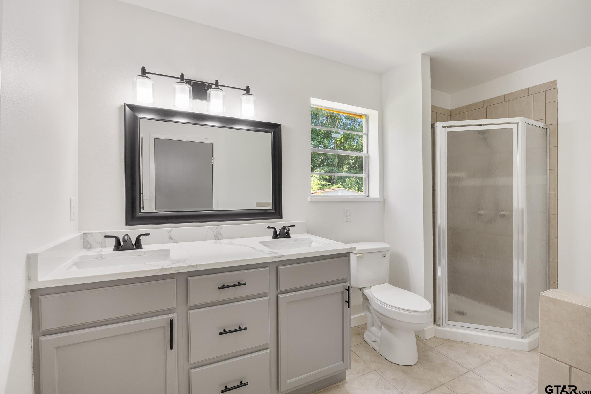1538 North Hill Road Tyler, TX 75702 - Photo 26 of 29 a bathroom with a toilet sink and mirror