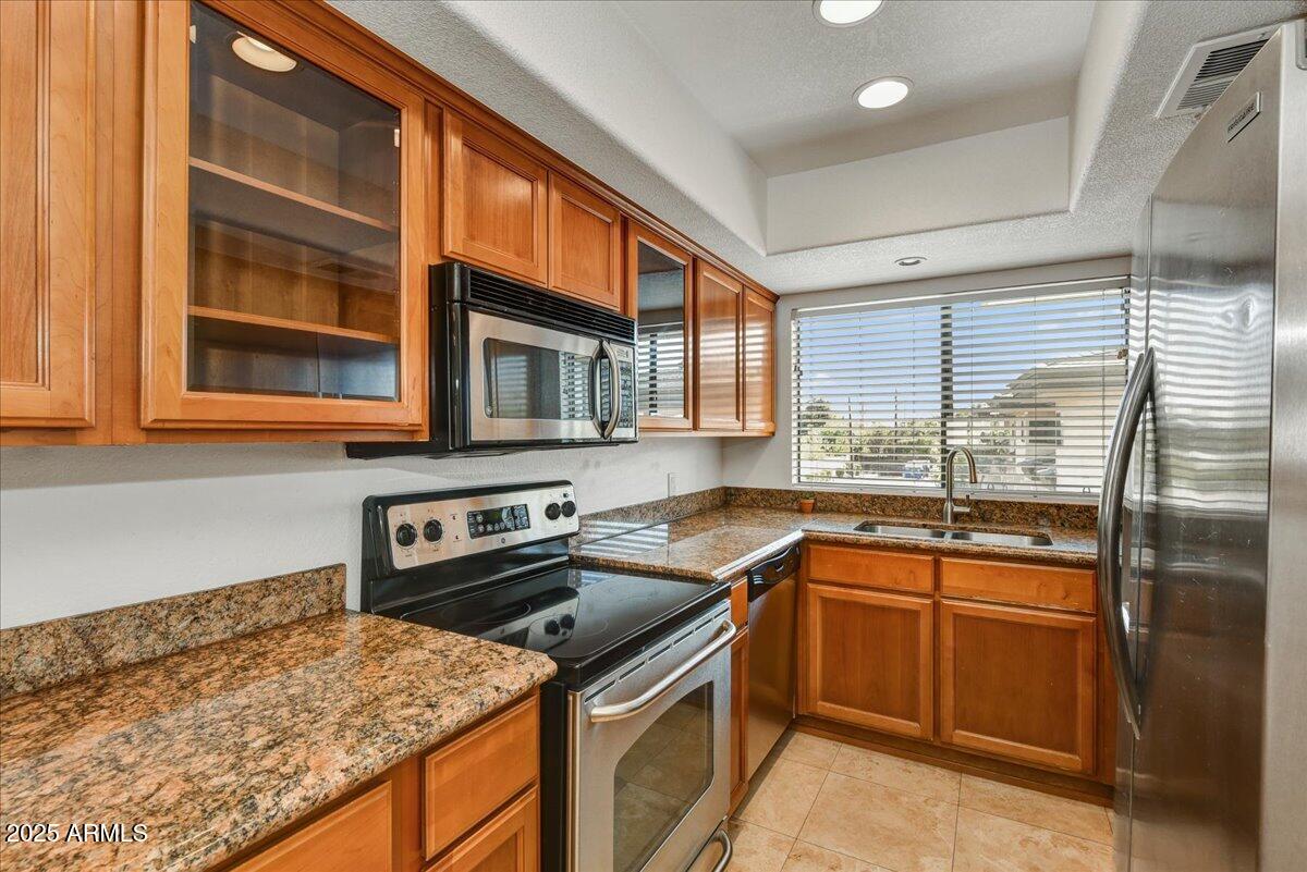 3235 East Camelback Road, Unit 218 Phoenix, AZ 85018 - Photo 12 of 23 a kitchen that has a sink and a stove