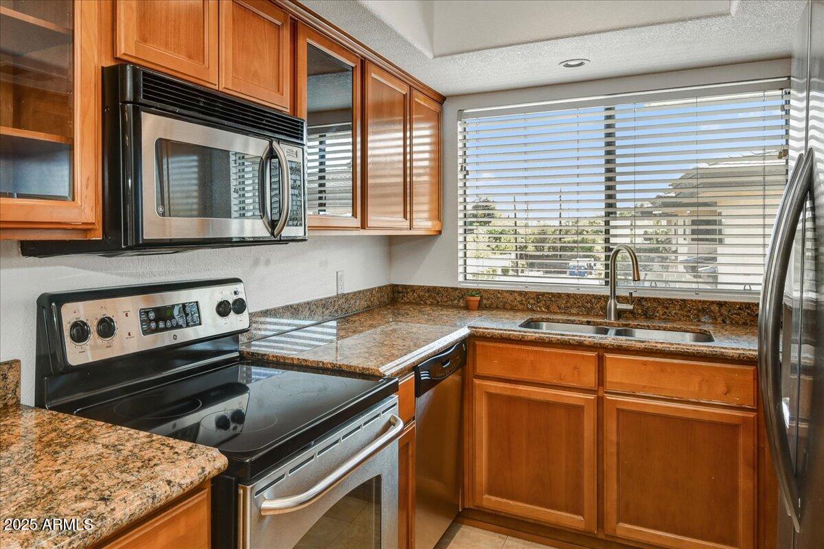 3235 East Camelback Road, Unit 218 Phoenix, AZ 85018 - Photo 13 of 23 a kitchen with a stove and a sink