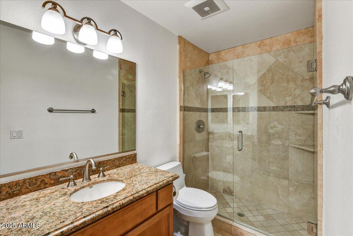 3235 East Camelback Road, Unit 218 Phoenix, AZ 85018 - Photo 17 of 23 a bathroom with a granite countertop sink toilet and shower