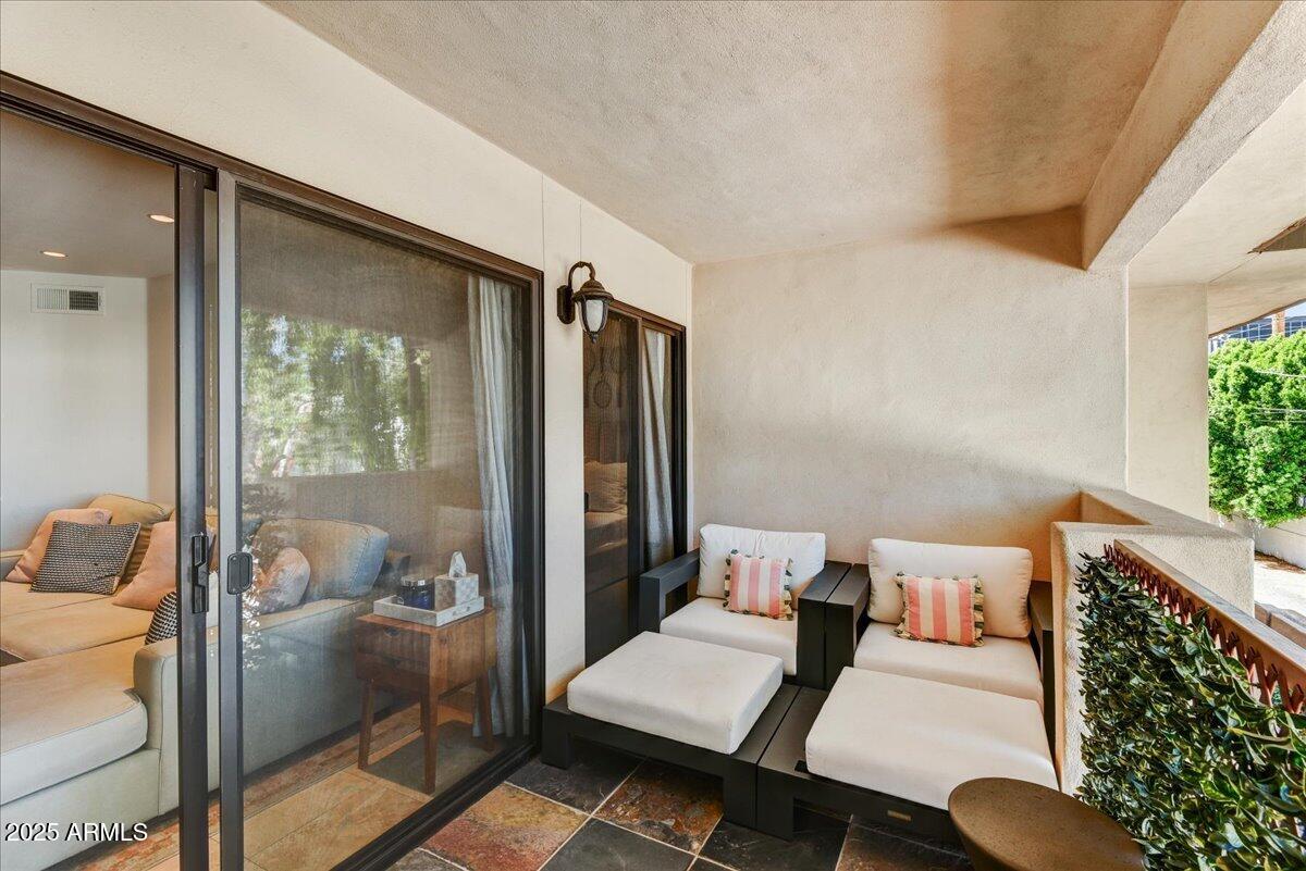 3235 East Camelback Road, Unit 218 Phoenix, AZ 85018 - Photo 18 of 23 a living room with furniture and a window