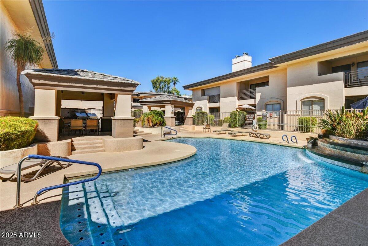 3235 East Camelback Road, Unit 218 Phoenix, AZ 85018 - Photo 22 of 23 a view of a house with swimming pool and sitting area
