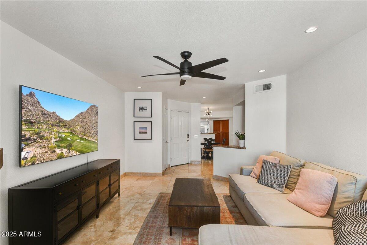 3235 East Camelback Road, Unit 218 Phoenix, AZ 85018 - Photo 7 of 23 a living room with furniture and a flat screen tv