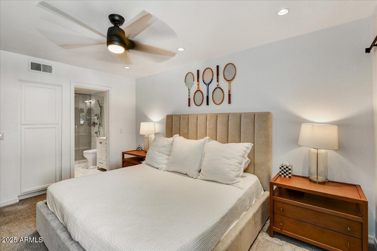 3235 East Camelback Road, Unit 218 Phoenix, AZ 85018 - Photo 8 of 23 a bedroom with a bed and a lamp on table