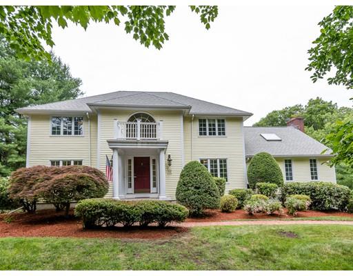 a front view of a house with a garden and plants