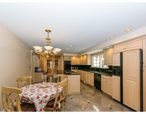 52 Crestview Road Milton, MA 02186 - Photo 12 of 25 a kitchen with stainless steel appliances kitchen island granite countertop a refrigerator a stove a sink dishwasher and white cabinets with wooden floor