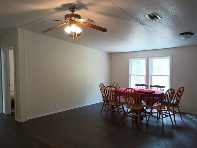 a view of a dining room with furniture and chandelier
