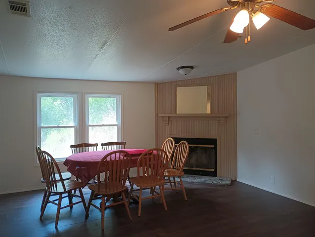 a dining room with furniture and window